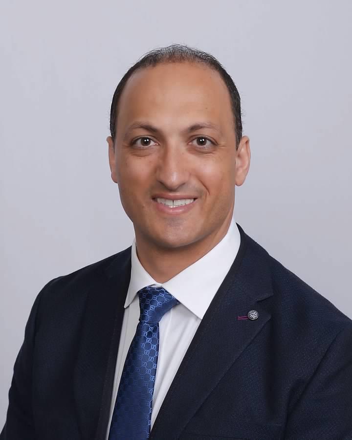 Dr. Ramis Gheith in a navy suit